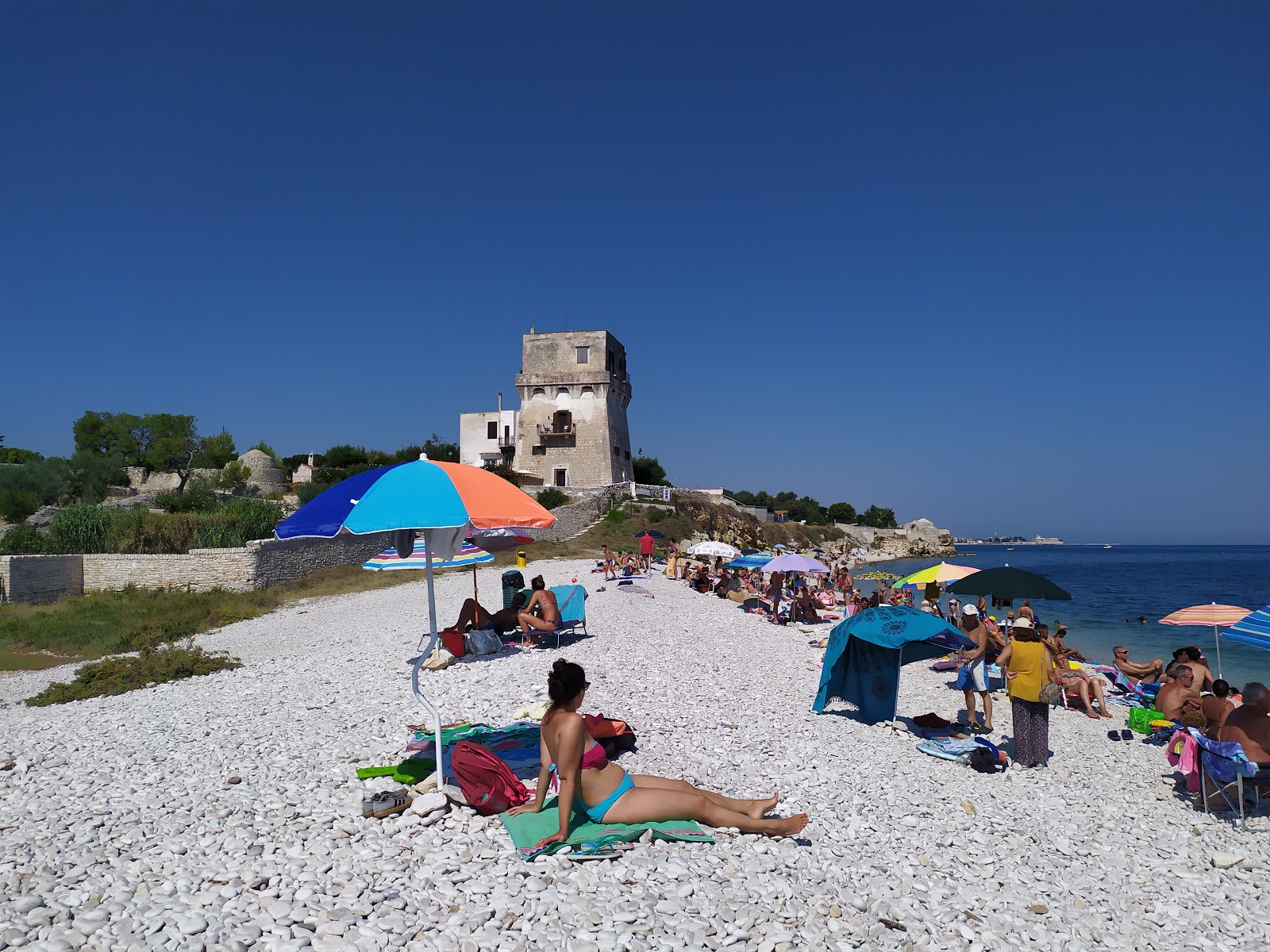 Fotografija Spiaggia La Torretta z lahki kamenček površino