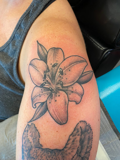 Explore feminine shoulder tattoo ideas, creative tattoo ideas in Palm Harbor, available at Angry Owl Tattoo and Piercing