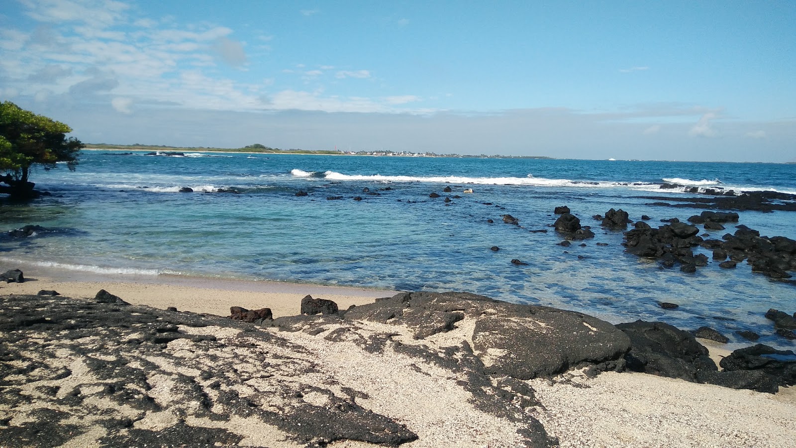 Valokuva Playa del Amorista. pinnalla kirkas hiekka ja kivet:n kanssa