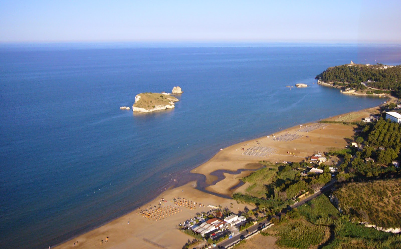 Foto av Spiaggia di Portonuovo med turkos rent vatten yta