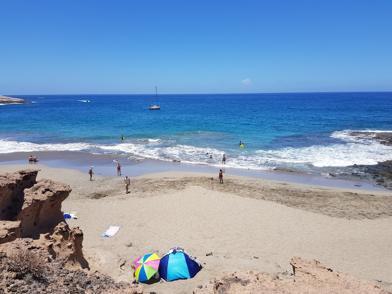 Fotografie cu La Caleta de Adeje cu o suprafață de nisip fin strălucitor