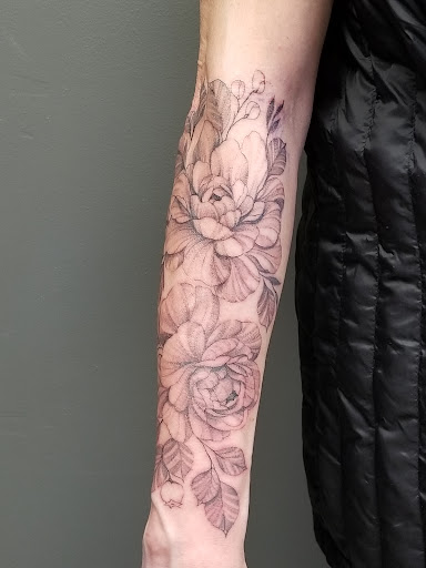 Explore december birth flower tattoo ideas, creative tattoo ideas in Anchorage, available at Dragon Rays Tattooing