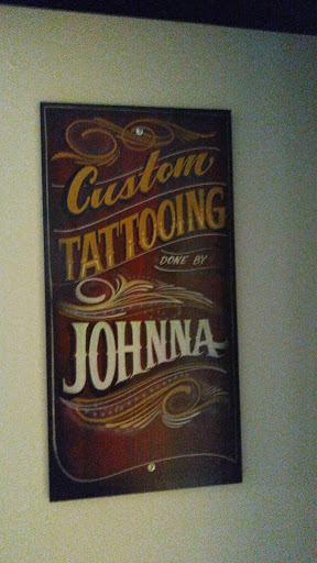 Explore book dragon tattoo ideas, creative tattoo ideas in Omaha, available at Liquid Courage Tattoos