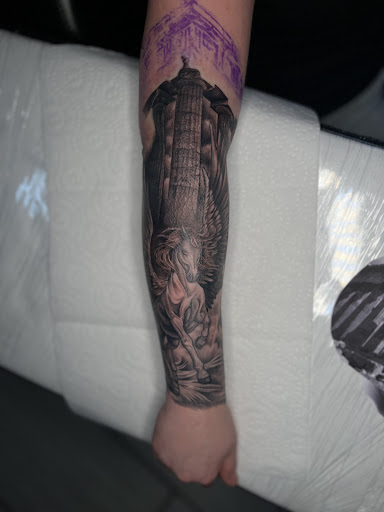 Explore tattoo flag ideas, creative tattoo ideas in Cadillac, available at Limitless Ink Tattoo Studio