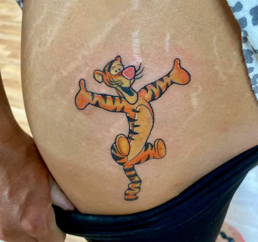 Explore c section scar tattoo ideas, creative tattoo ideas in Benton, available at Spectrum Tattoo