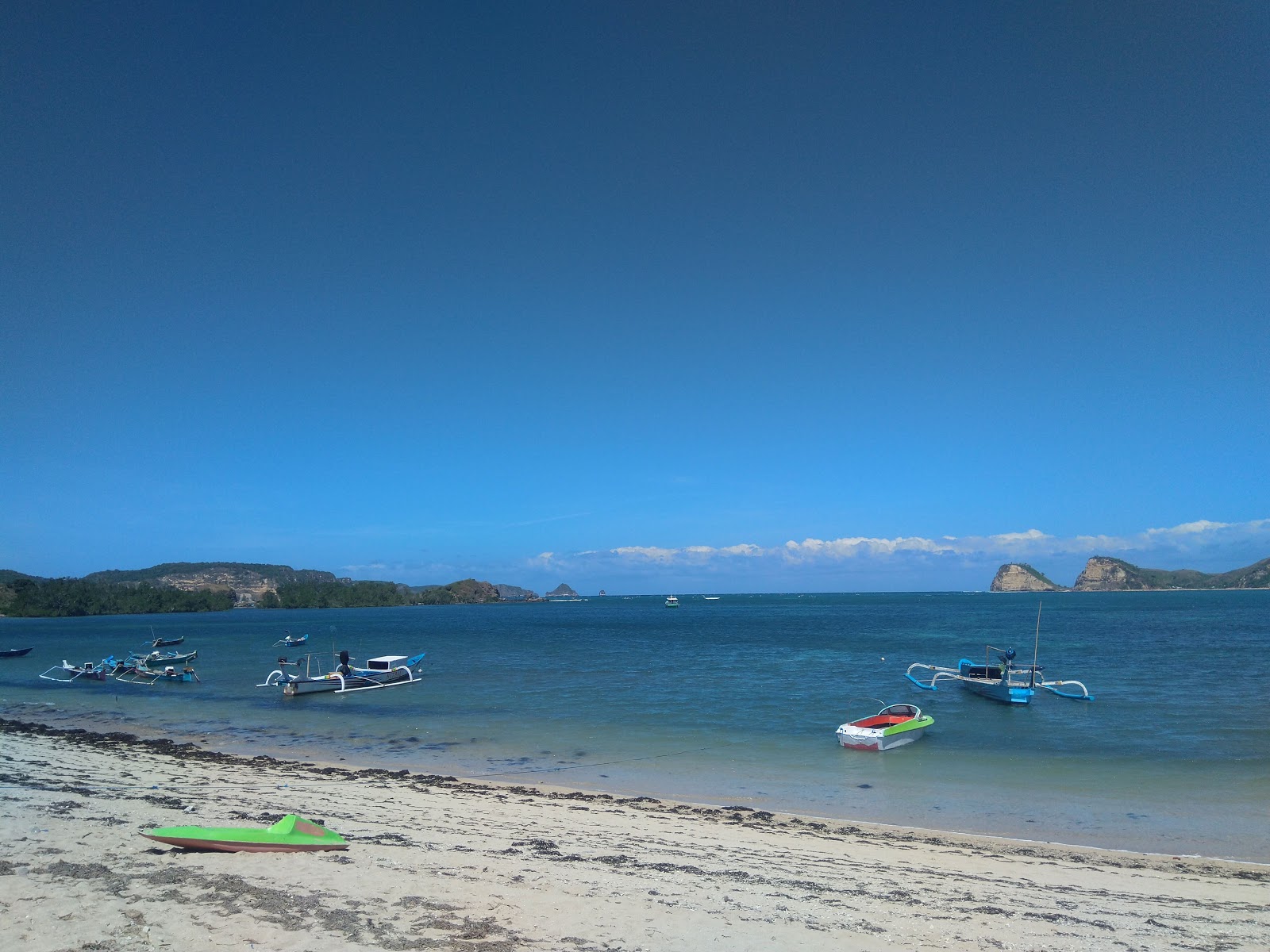 Photo of Dondon Beach surrounded by mountains