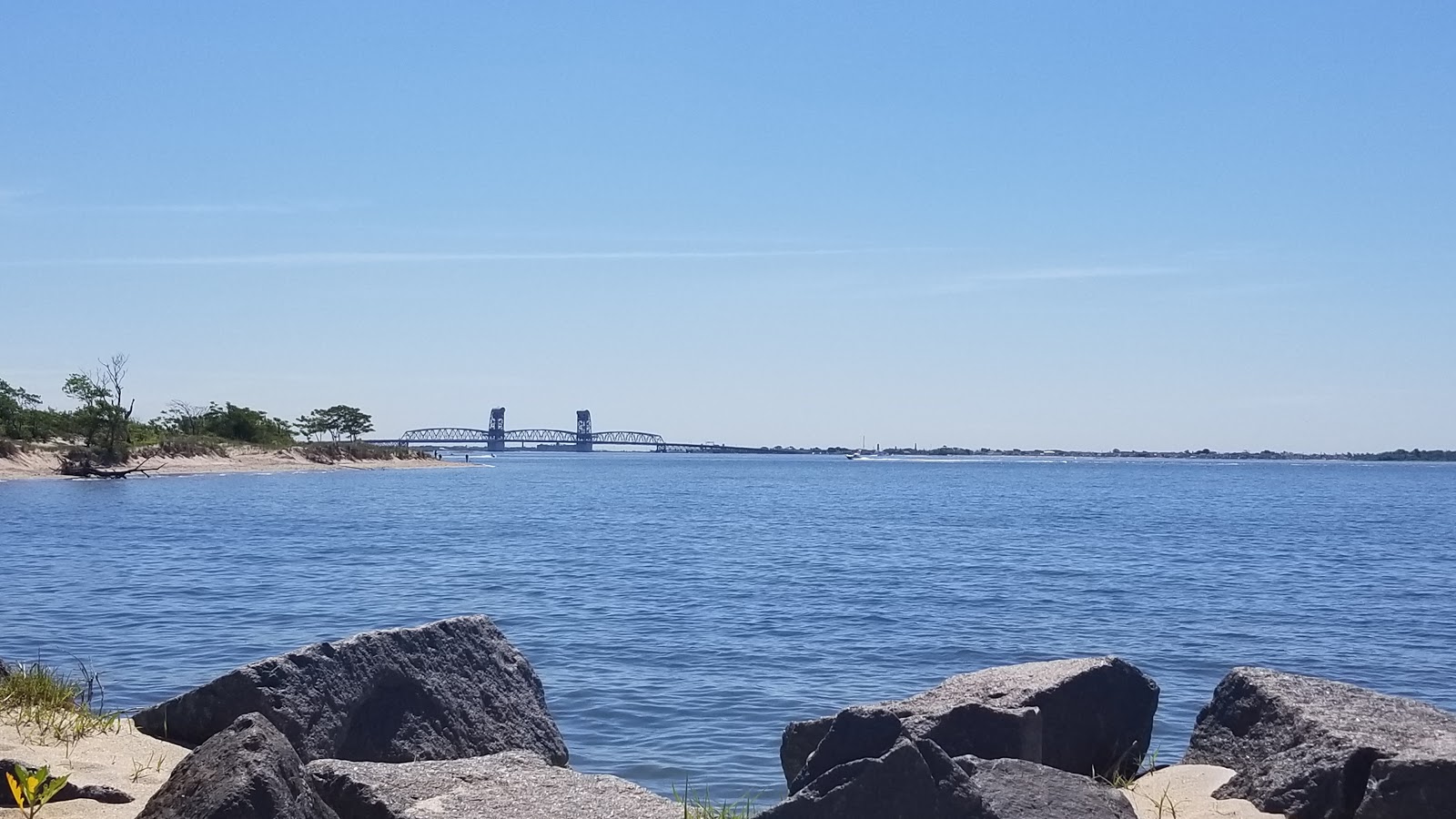 Foto av Plumb Beach med grönt vatten yta