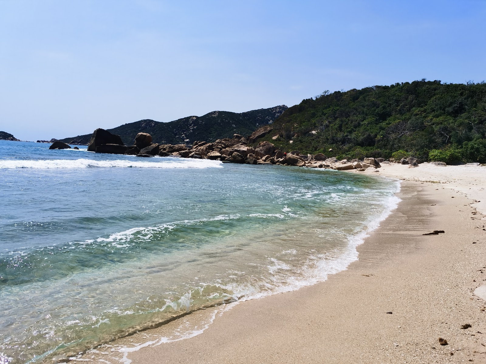 Fotografija Bai Cay Bang Beach z svetel pesek in kamni površino