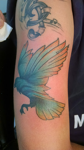 Explore bicep tattoo ideas for men, creative tattoo ideas in Hanceville, available at Wildman Tattoo and Body Piercing