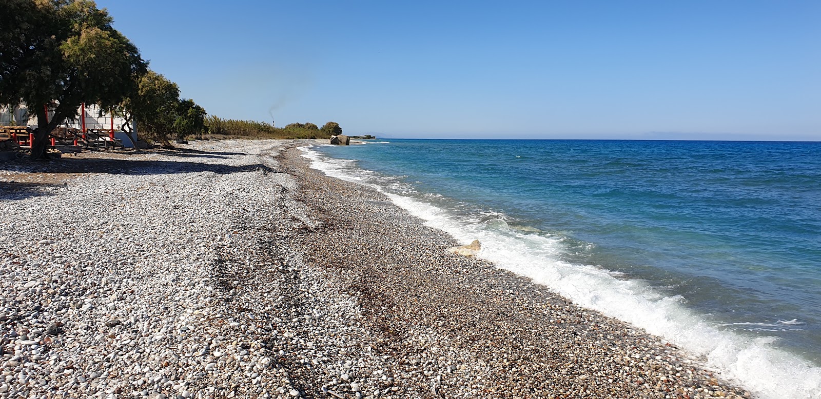 Fotografija Paradisi Beach z modra voda površino