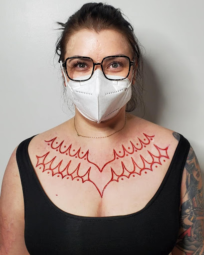 Find tattoo between breast ideas for your next unique tattoo in Phoenix at Wholehearted Body Piercing
