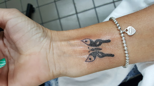 Explore fine line hand tattoo ideas, creative tattoo ideas in Huntsville, available at The Purple Goat Tattoos