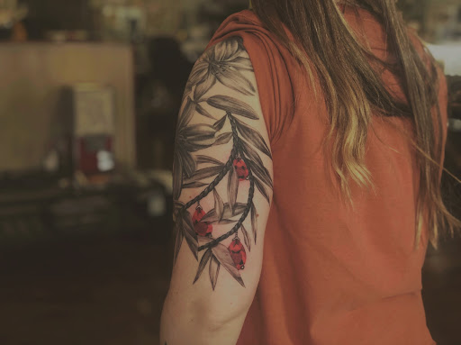 Explore daisy flower tattoo ideas, creative tattoo ideas in Graham, available at Transcendence Art Studio & Tattoo