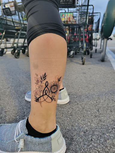 Explore flower leg tattoo ideas, creative tattoo ideas in New Bern, available at Firehouse Tattoo.