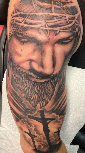 Explore hand tattoo ideas for man, creative tattoo ideas in Largo, available at Alchemy Tattoos and Body Piercings