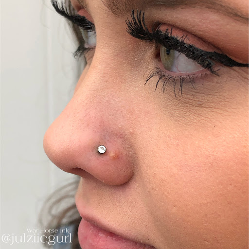 Explore neck tattoo ideas for females, creative tattoo ideas in Kent, available at War Horse Ink