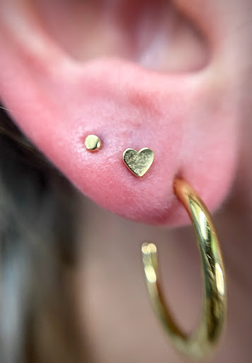 Explore fine line tattoo ideas, creative tattoo ideas in Orange, available at Symbiosis Body Piercing