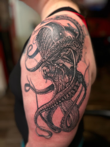 Explore solar eclipse tattoo ideas, creative tattoo ideas in Lander, available at Blackblood Tattoo and Piercing