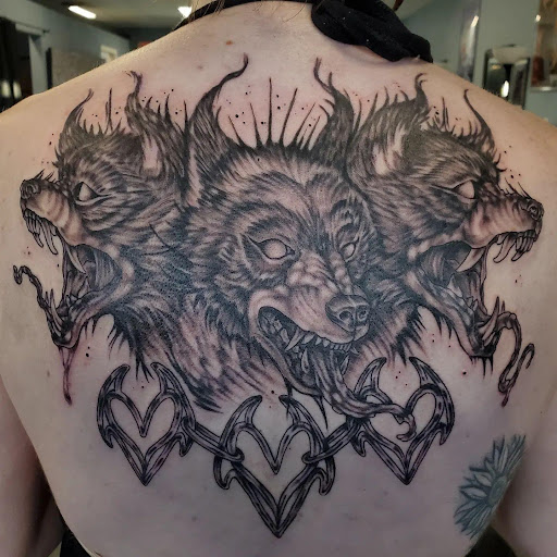Find small tattoo between breast ideas for your next unique tattoo in Palm Harbor at Angry Owl Tattoo and Piercing