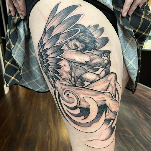 Explore tattoo ideas for top of leg, creative tattoo ideas in Dubuque, available at The Crows Nest