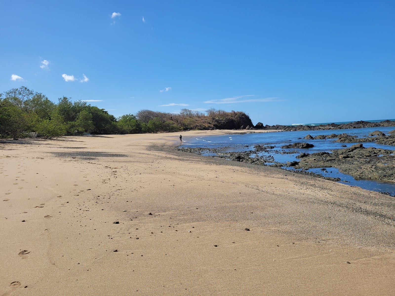 Valokuva Playa Callejonesista. pinnalla kirkas hiekka ja kivet:n kanssa