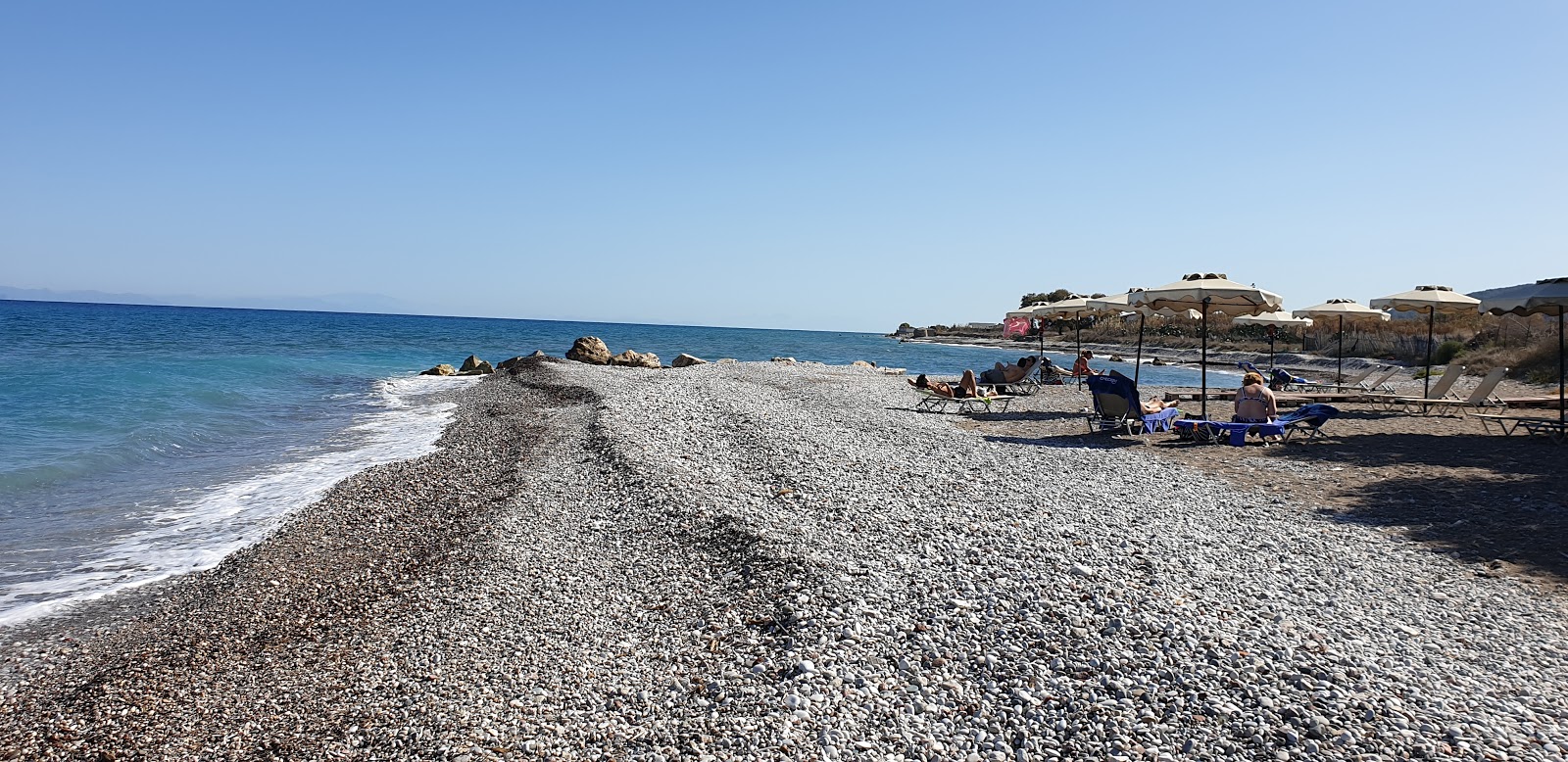 Foto von Paradisi Beach mit heller sand&kies Oberfläche