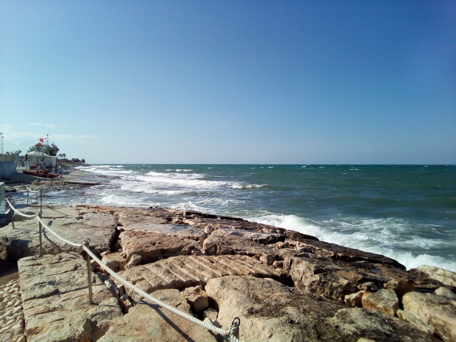 Photo of Lido Belvedere beach with rocks cover surface