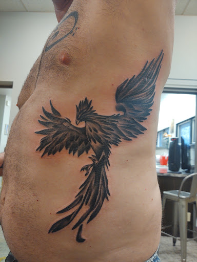 Explore snake sleeve tattoo ideas, creative tattoo ideas in Grand Forks, available at Blaq Taffy Tattoo