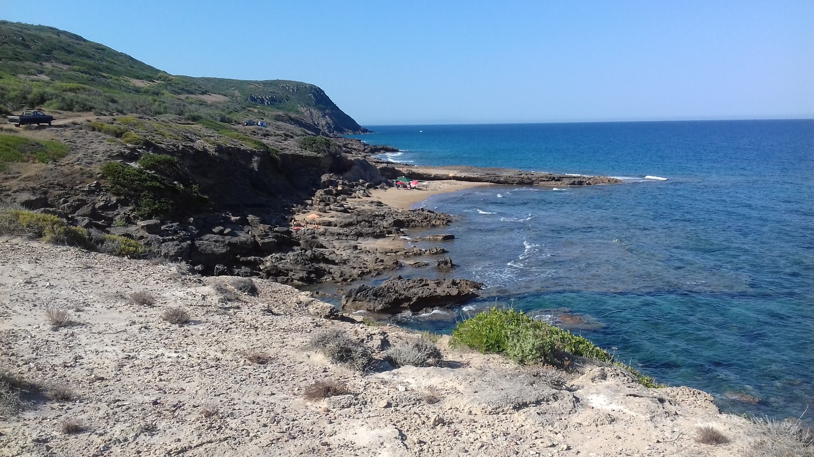 Foto di Cala dello Scoglio Rosso Beach con una superficie del terreno roccioso