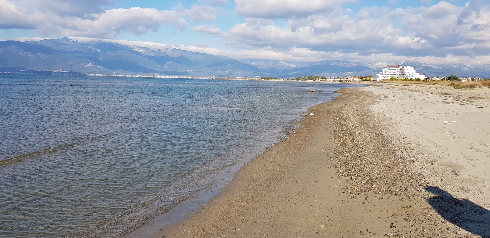 Foto de Dudu beach con arena beige superficie