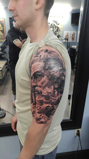 Explore hood tattoo ideas for men, creative tattoo ideas in Sanford, available at Venom Ink Tattoo