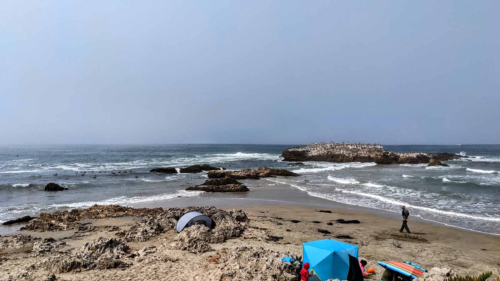 Photo of Pescadero Beach surrounded by mountains