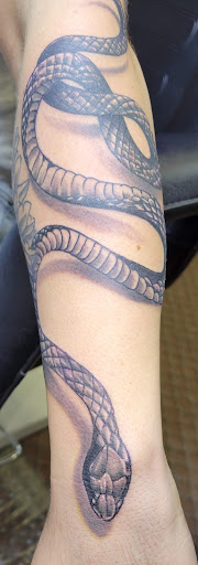 Explore black sleeve tattoo ideas, creative tattoo ideas in Angola, available at Hoodlum Ink