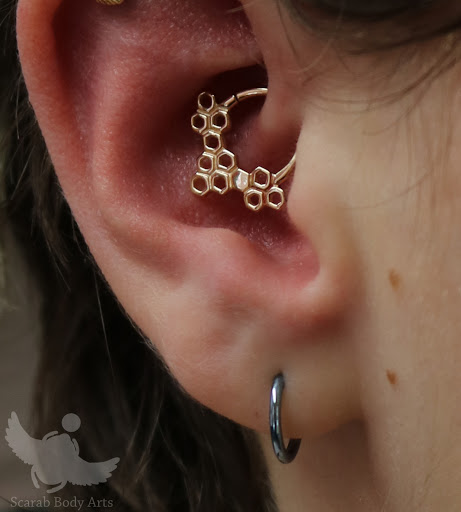 Find tattoo ideas under breast for your next unique tattoo in Syracuse at Scarab Body Arts