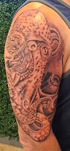 Explore tattoos for behind the ear ideas, creative tattoo ideas in Oviedo, available at Fine Ink Studios Tattoos