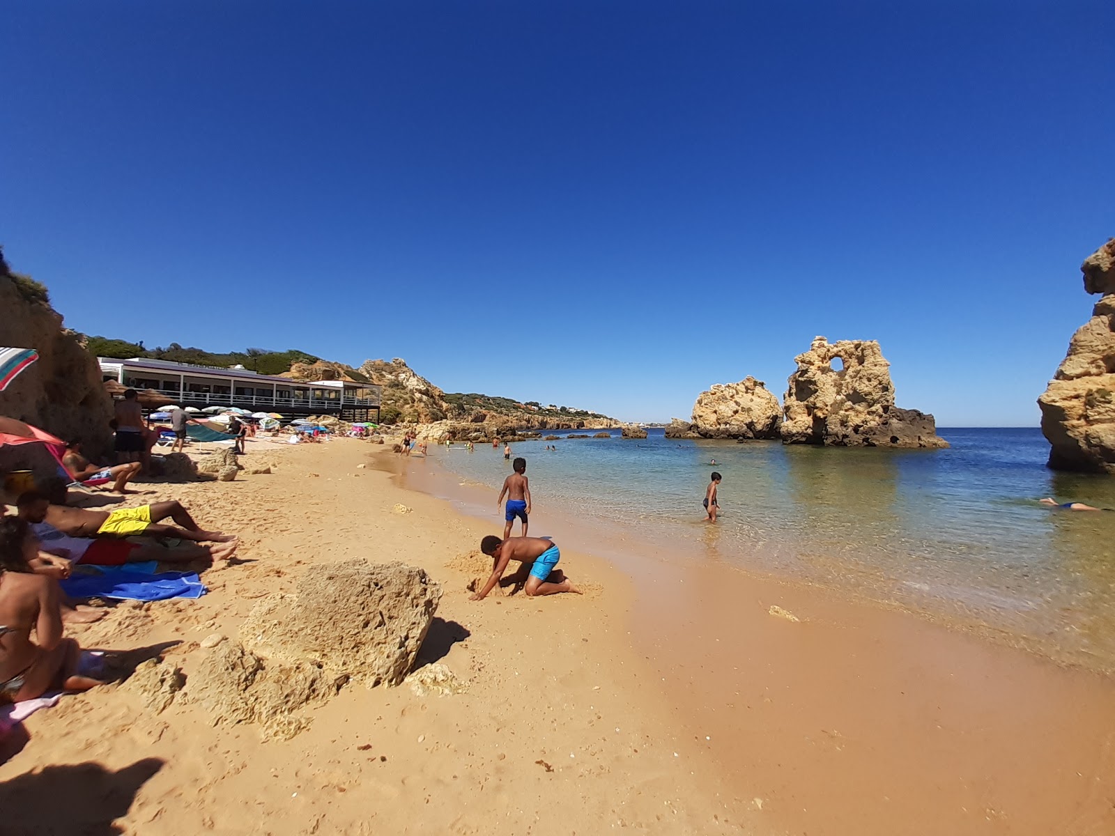 Foto av Praia dos Arrifes omgiven av klippor