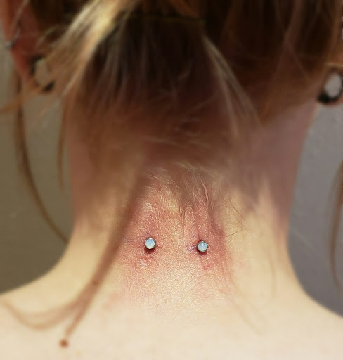 Find inbetween boob tattoo ideas for your next unique tattoo in Nampa at Hippie Hoops and Holes