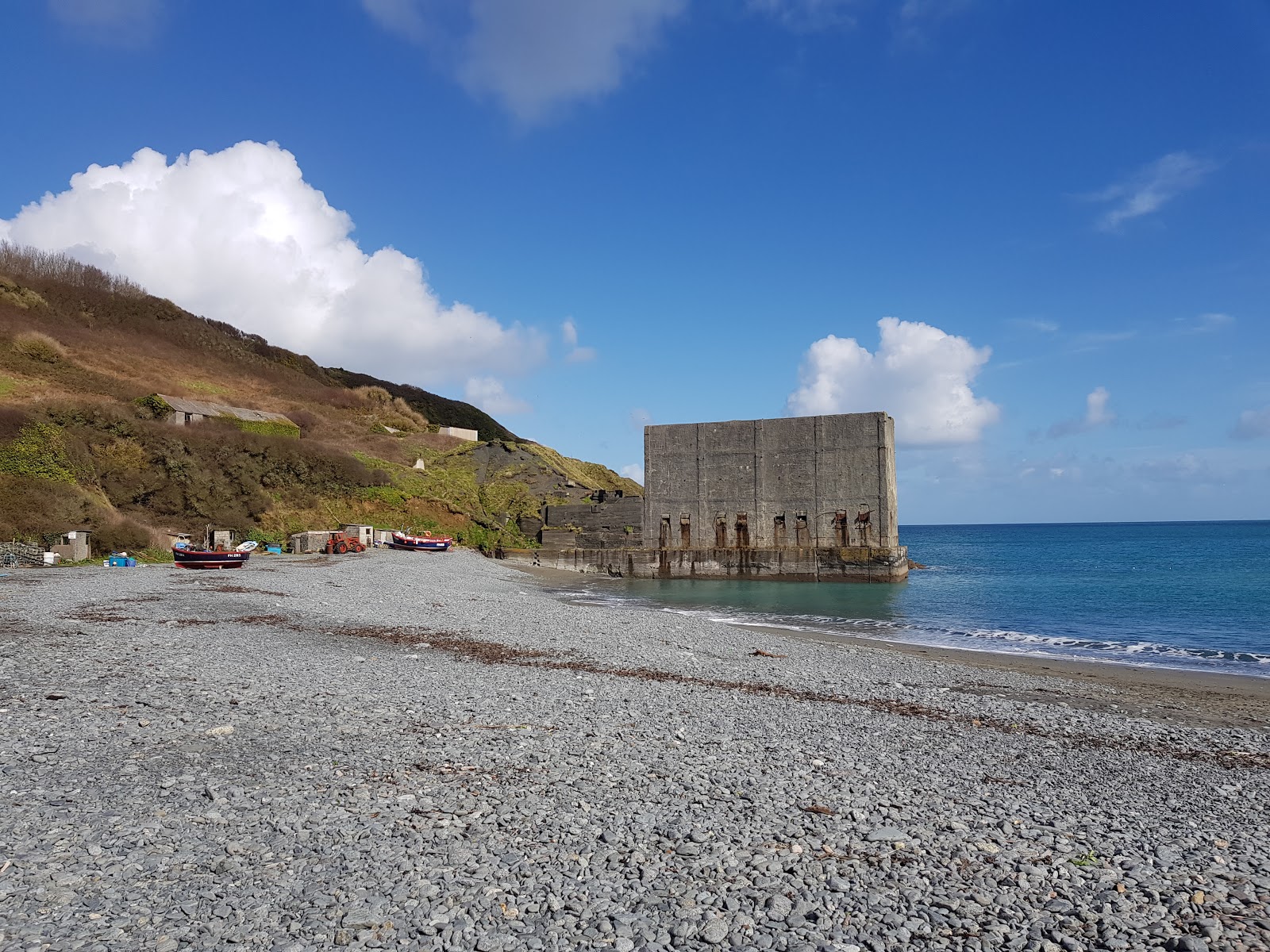 Photo of Porthoustock beach with gray pebble surface