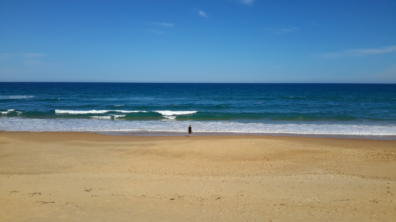 Foto av Ninety Mile Beach med turkos rent vatten yta