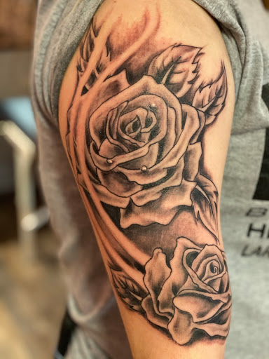 Explore dog print tattoo ideas, creative tattoo ideas in Pikeville, available at The Carbon Canary Tattoo Studio