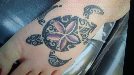 Explore purple flower tattoo ideas, creative tattoo ideas in Lima, available at White Wizard Tattoo & Body Piercing