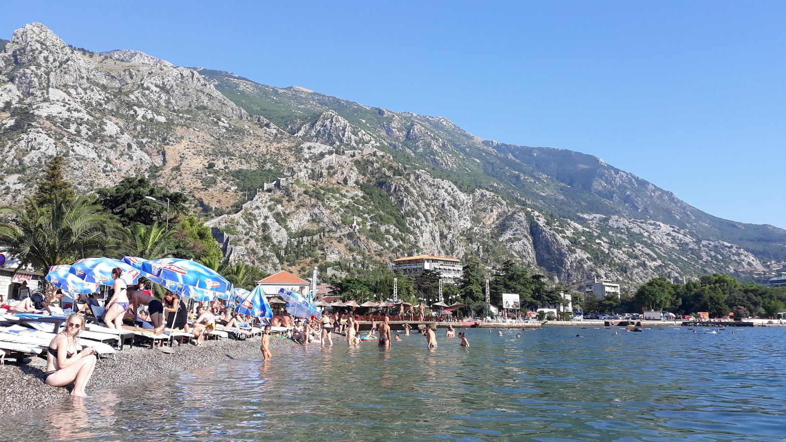 Photo of Kotor beach backed by cliffs