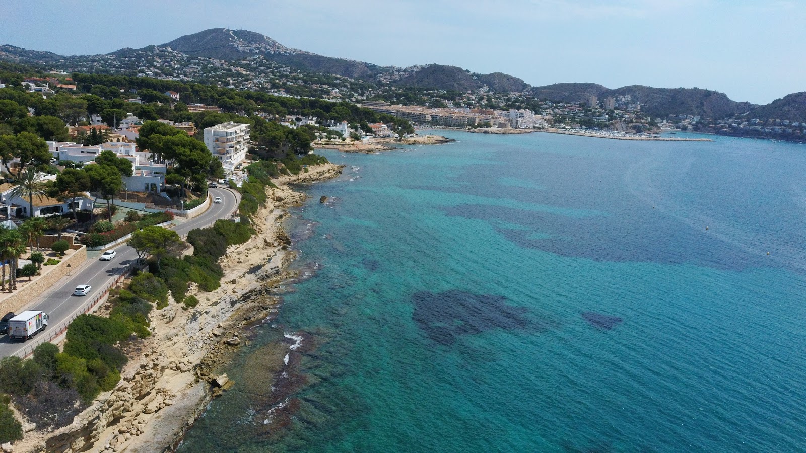 Photo of Moraira Beach with rocks cover surface