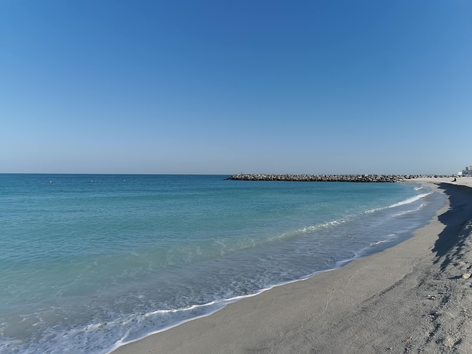 Fotografija Sharjah beach New z turkizna čista voda površino