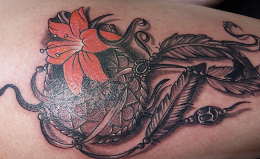 Explore side thigh tattoo ideas, creative tattoo ideas in Angola, available at Hoodlum Ink