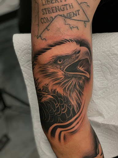 Explore cover up tattoo ideas for leg, creative tattoo ideas in Fayetteville, available at Sacred Raven Tattoo Shop