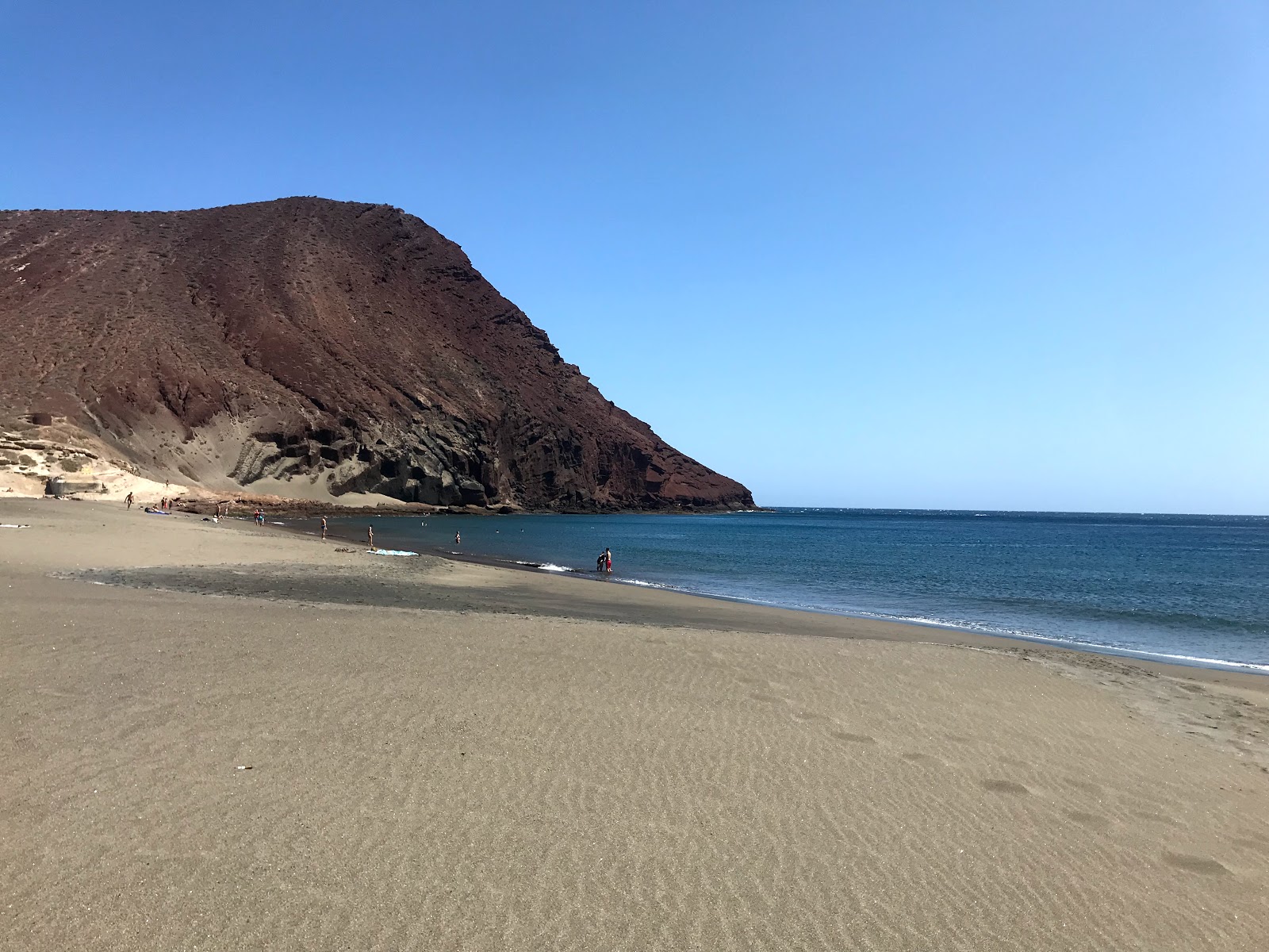 Foto von Playa de la Tejita mit brauner sand Oberfläche