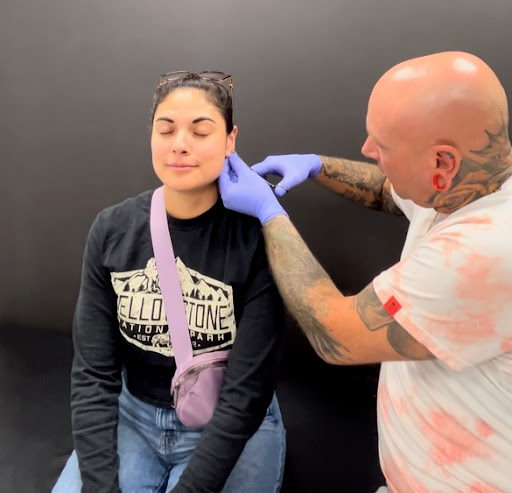 Explore ripped skin tattoo ideas, creative tattoo ideas in Kearney, available at Divine Tattoo Parlor North