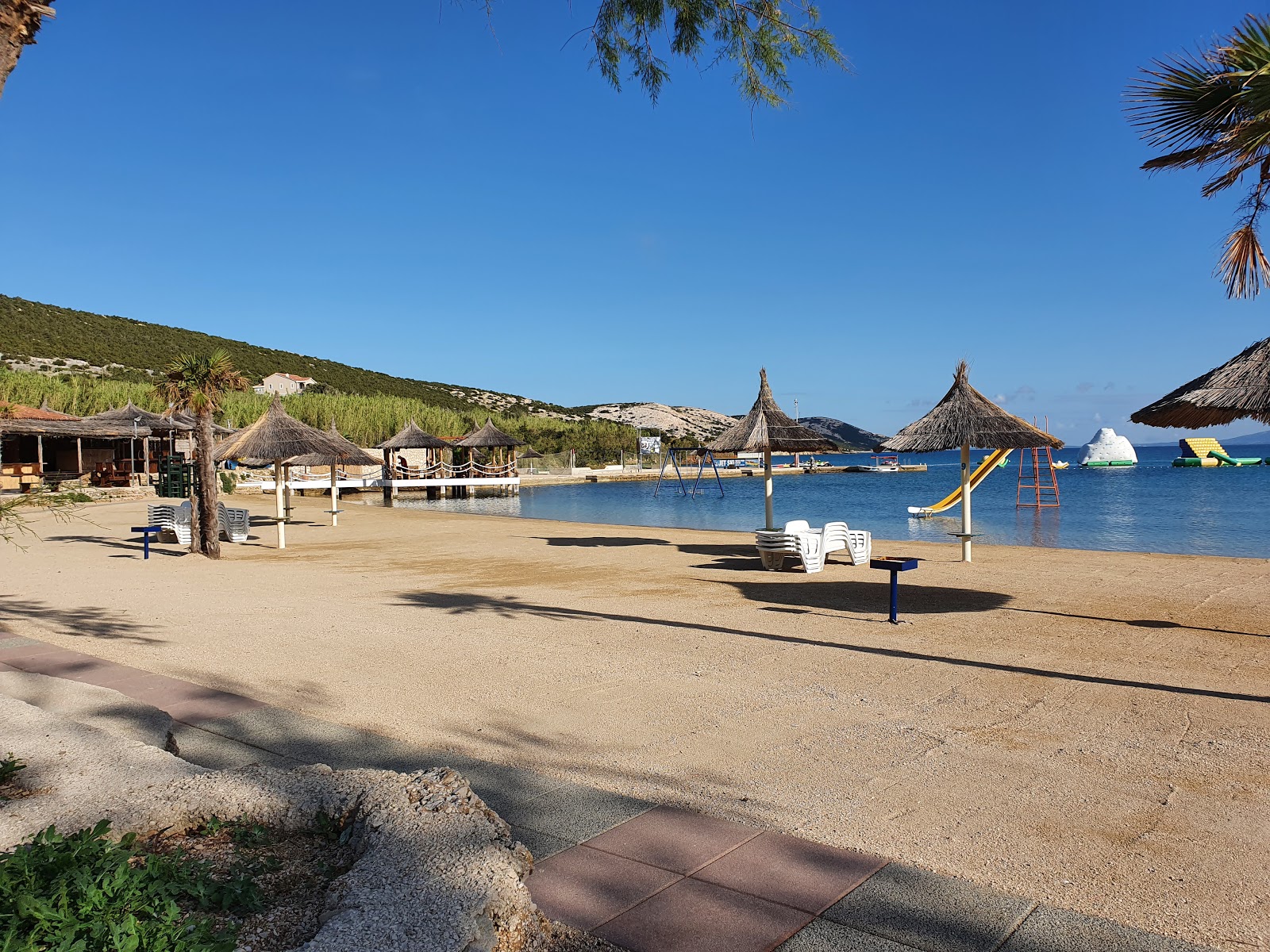 Fotografija Plaža Trincel na Planjki z lahki fini kamenček površino