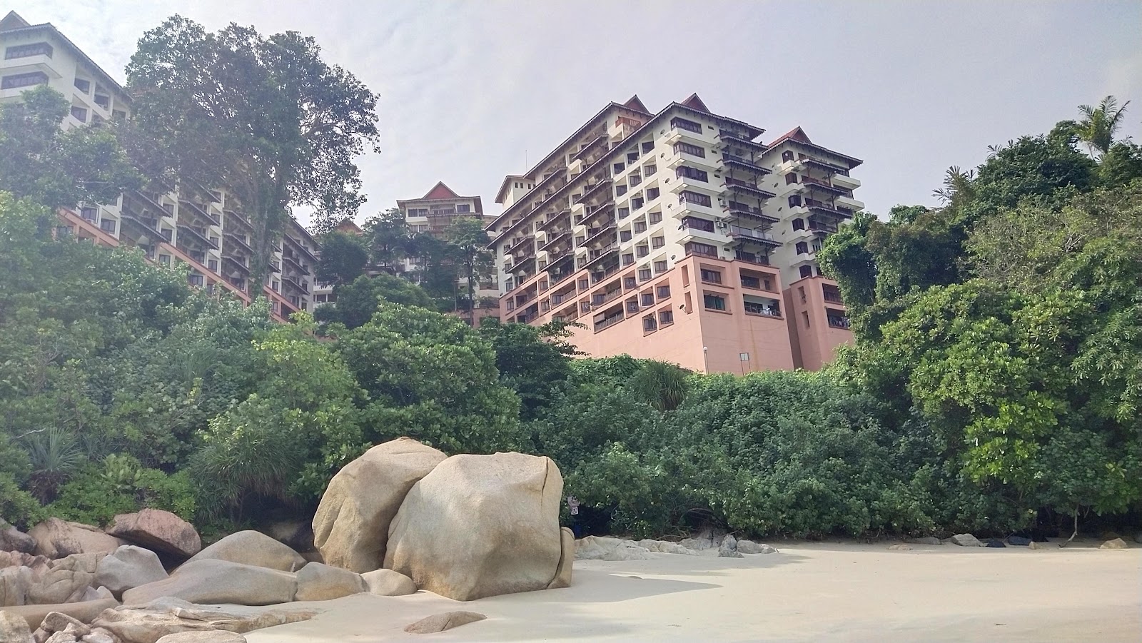 Fotografija Tanjung Tembeling Beach obkrožen z gorami